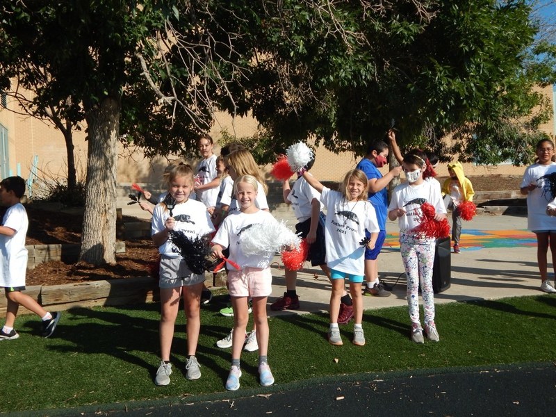 Group of children holding pom poms