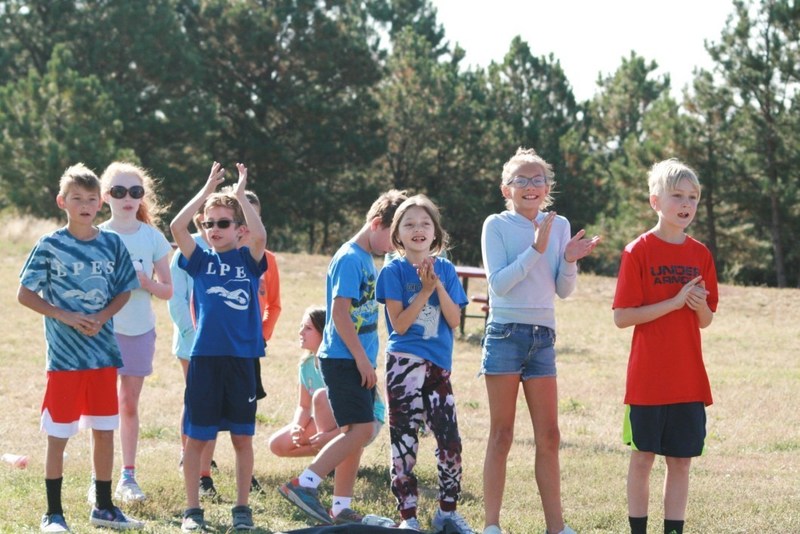 Group of kids on field lined up to play a field game