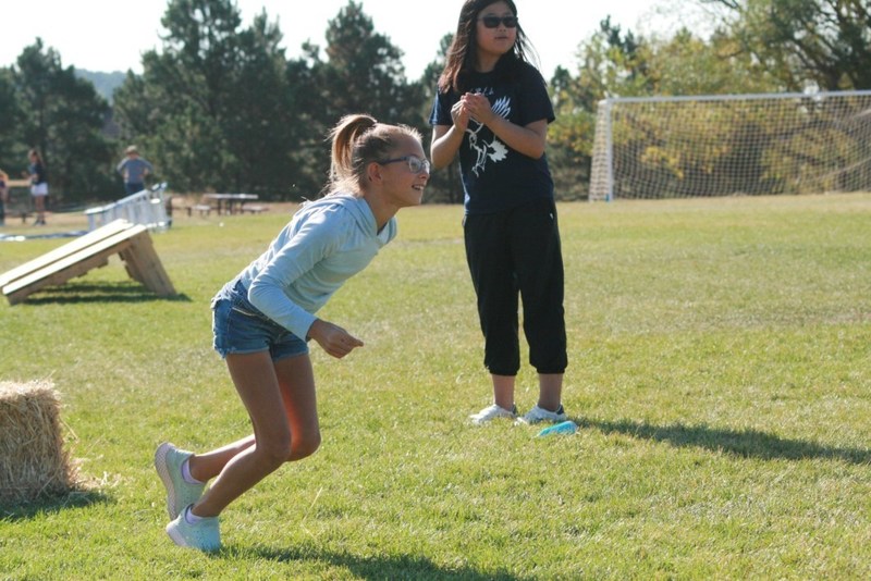 Student on field preparing to run