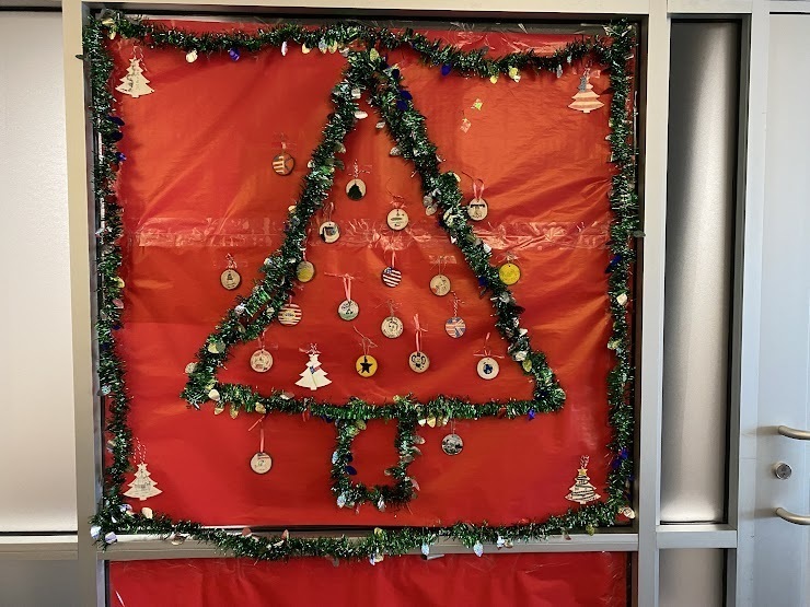 a door decorated with a Christmas tree and ornaments