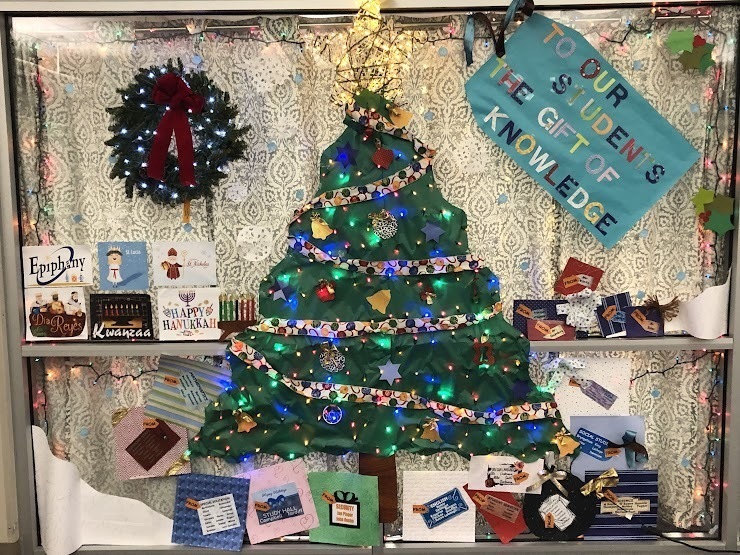 door decorated with a Christmas tree that says to our students the gift of knowledge