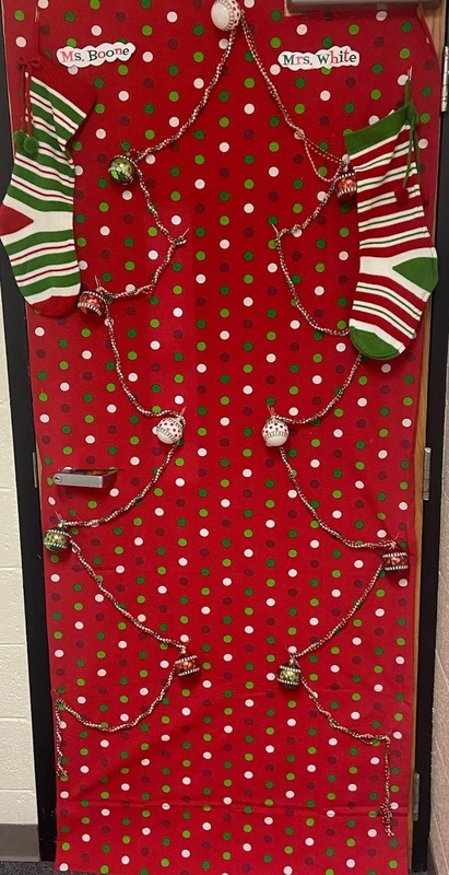 door decorated with Christmas tree outline and stockings